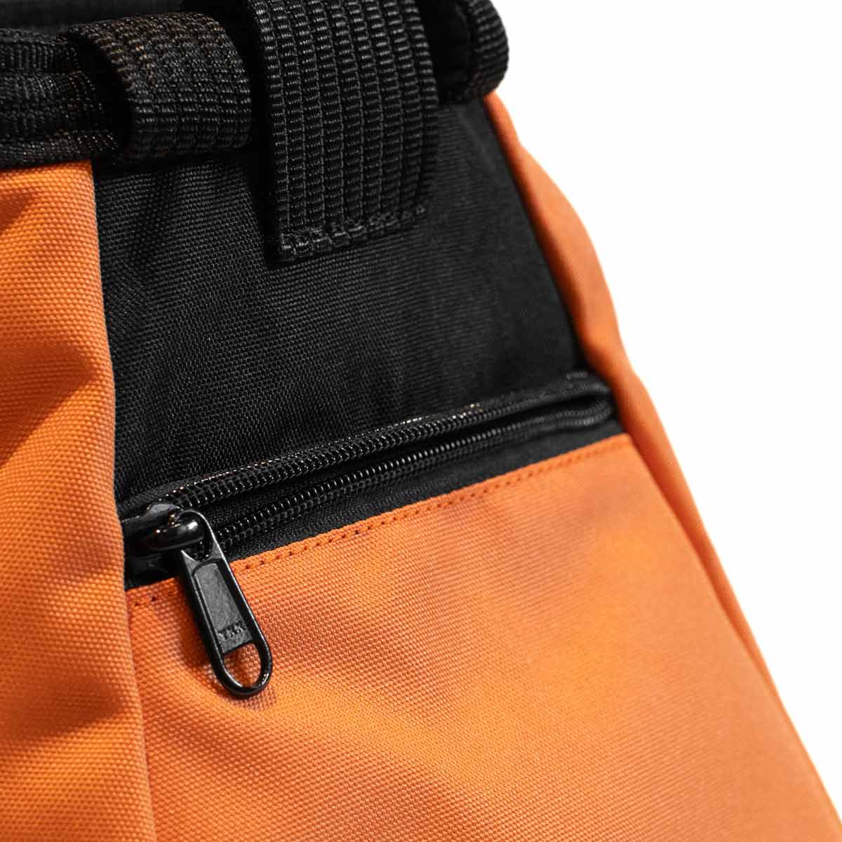 Bouldering chalk bucket in black and orange with zip pocket and carry strap