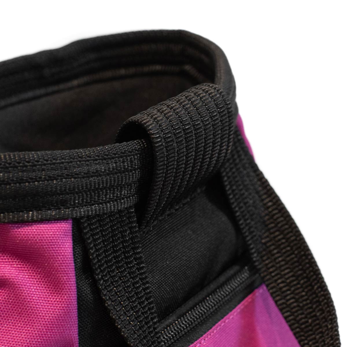 Close-up of black webbing and orange rim on a bouldering chalk bucket