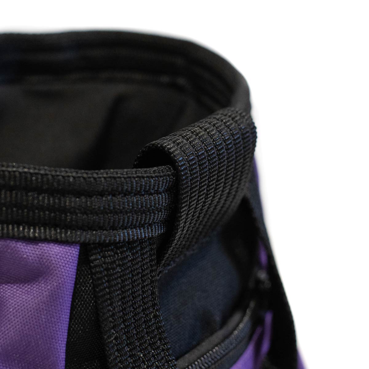 Close-up of black strap and stitched edge on purple chalk bucket