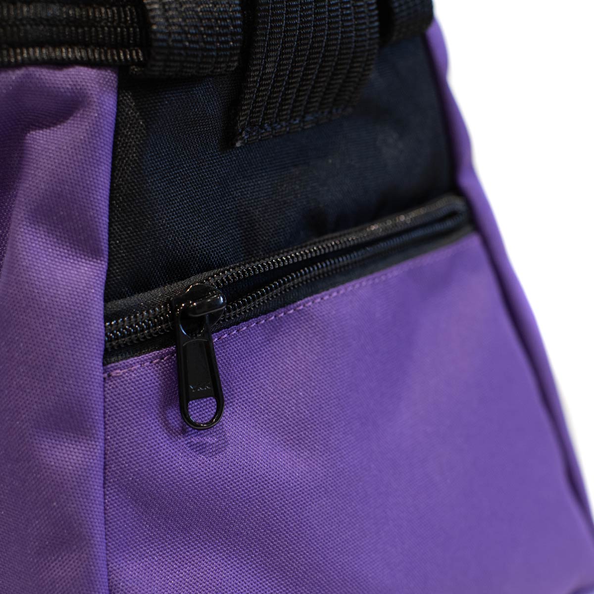 Close-up of black zipper and purple fabric panel on chalk bucket