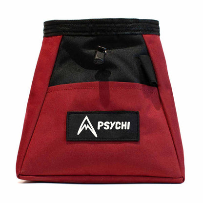 Dark red chalk bucket with black logo patch, drawcord top, and front storage section
