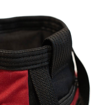 Close-up of black strap and side panel on dark red chalk bucket