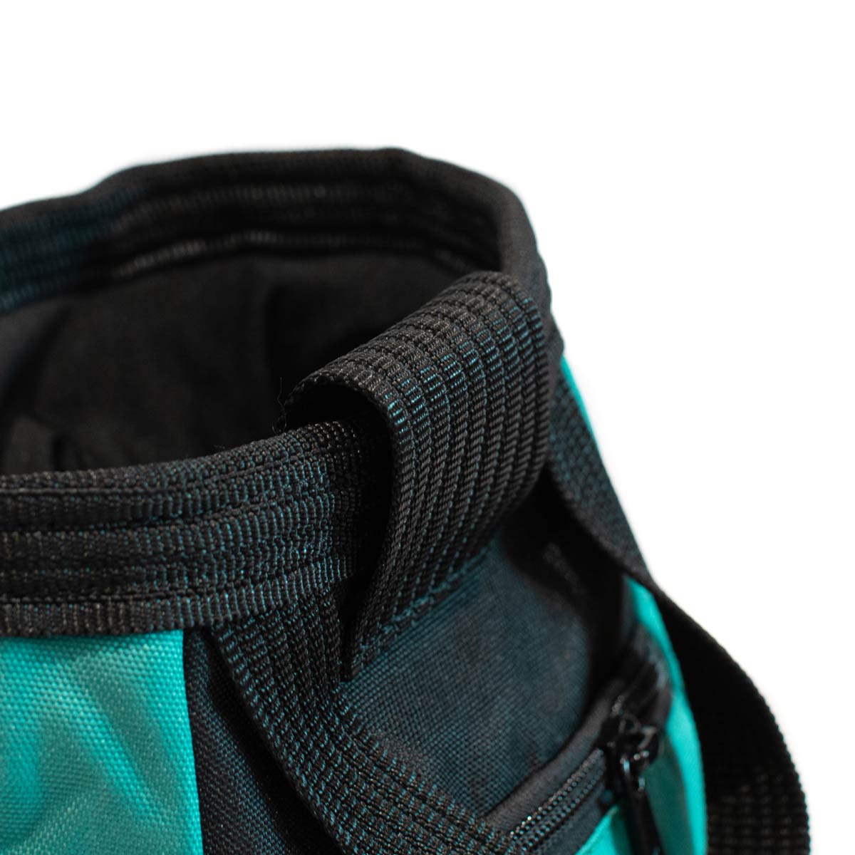 Bouldering chalk bucket close-up, black webbing edge and turquoise fabric panel