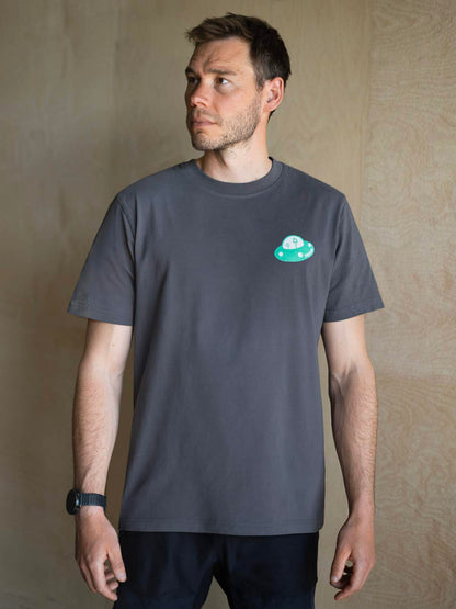 Grey organic cotton T-shirt on model, small circular alien mountain chest graphic