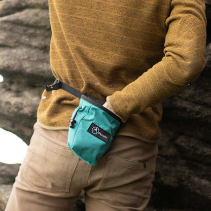 Turquoise climbing chalk bag with logo patch and black belt strap