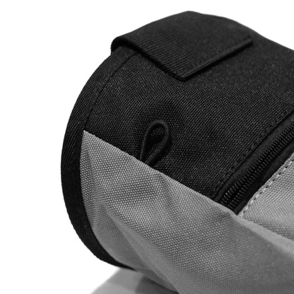 Close-up of grey climbing chalk bag rim with black zipper panel and fabric loop