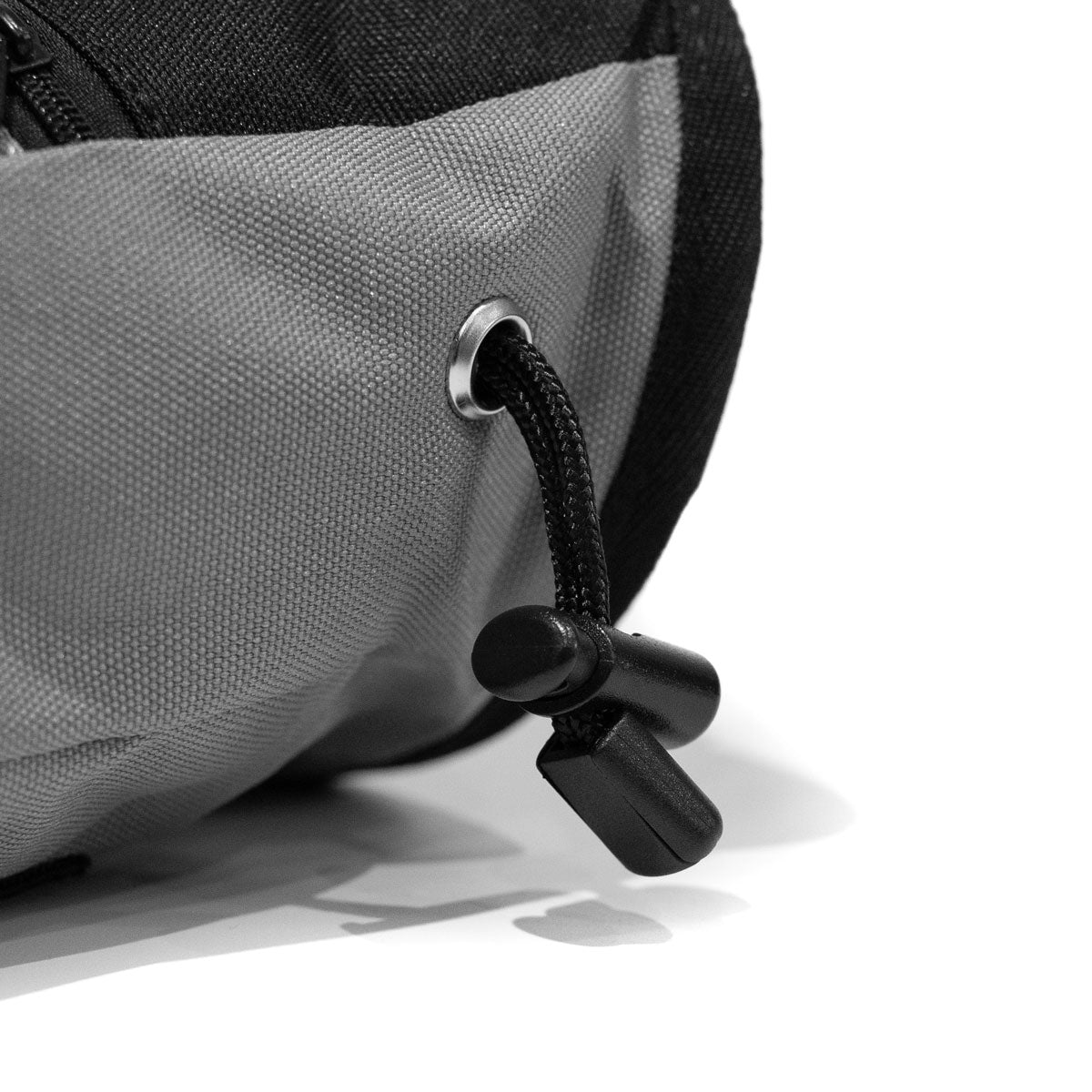 Grey climbing chalk bag side grommet with black drawcord and clip