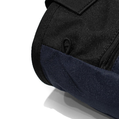 Close-up of navy climbing chalk bag with black zipper and fabric grommet