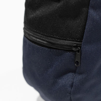 Close-up of navy climbing chalk bag with black zipper and stitched seams