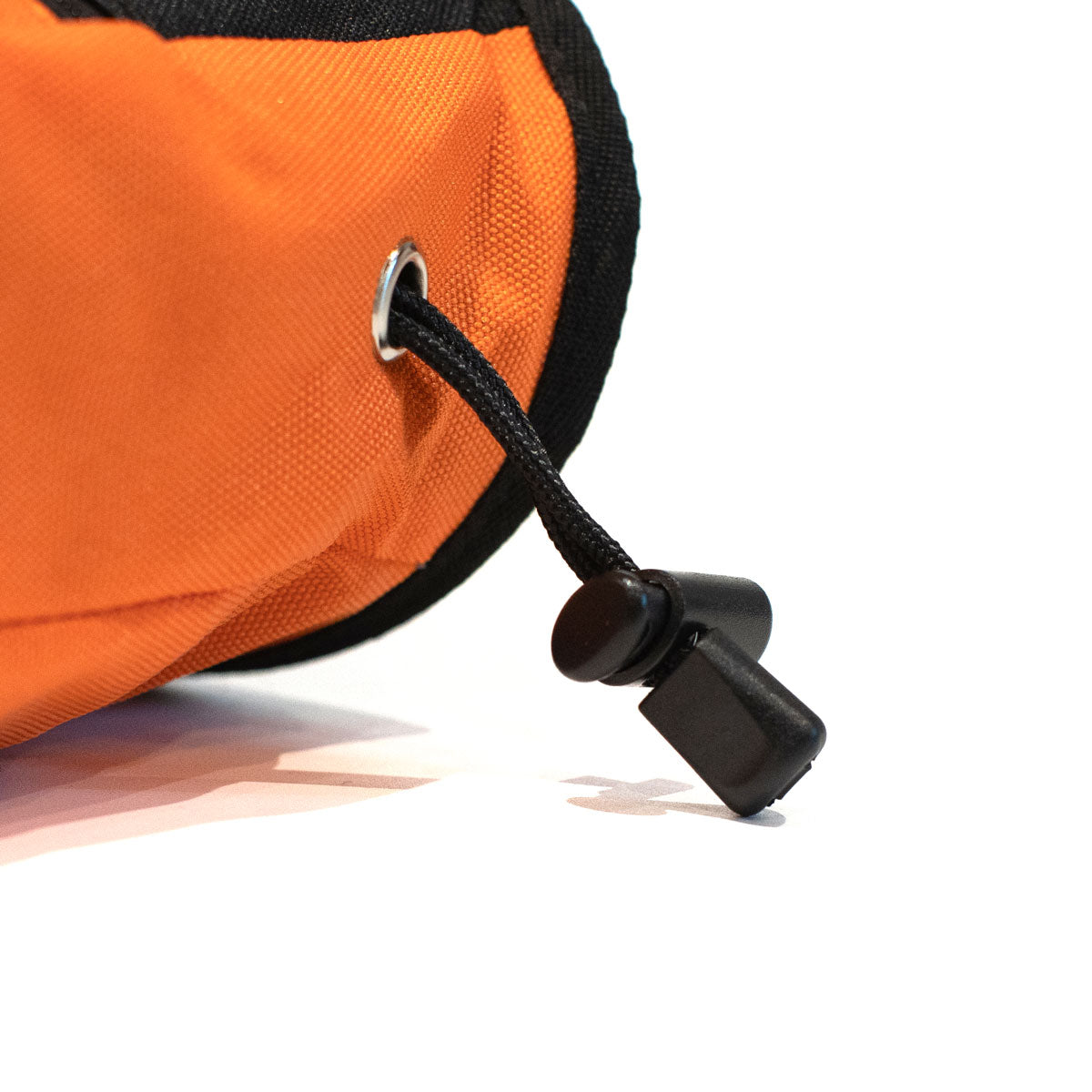 Orange climbing chalk bag with black drawcord adjuster and metal grommet