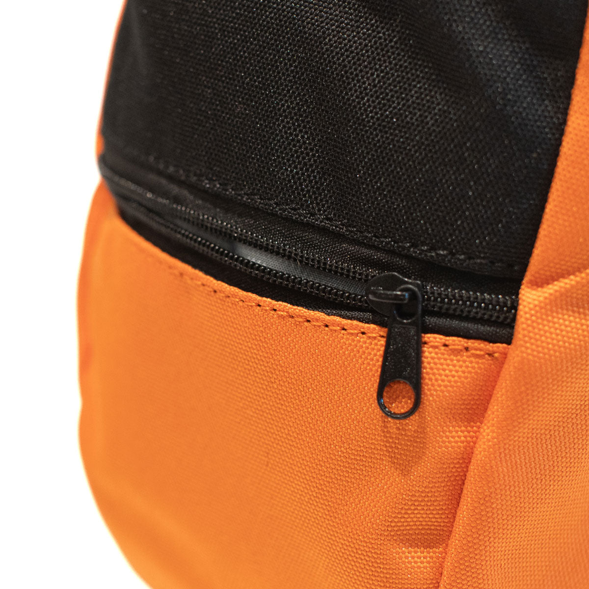 Orange climbing chalk bag close-up with black zipper and stitched front pocket