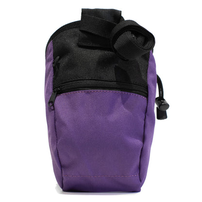 Purple climbing chalk bag with black top strap, zip pocket, and side pull tab