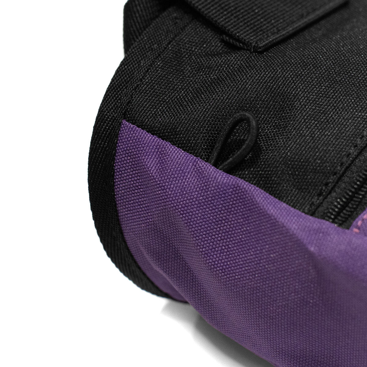 Purple climbing chalk bag with black back panel and top carrying strap loop
