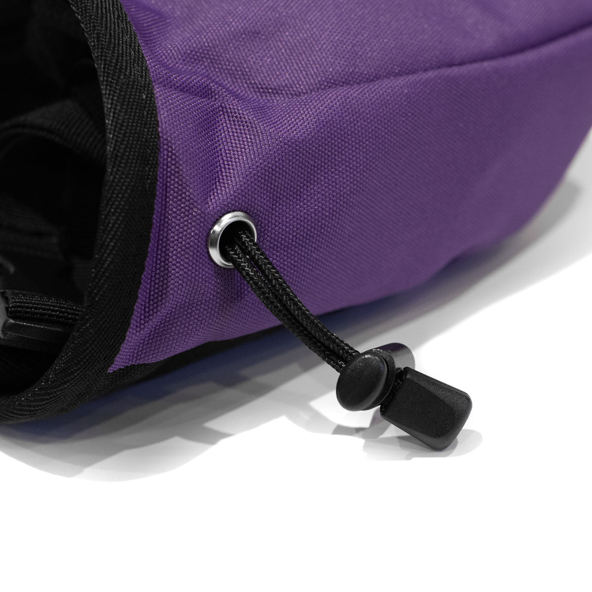 Purple climbing chalk bag with black carabiner-style clip and drawcord strap