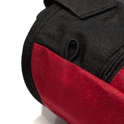 Red and black climbing chalk bag with zipper and fabric panel detail