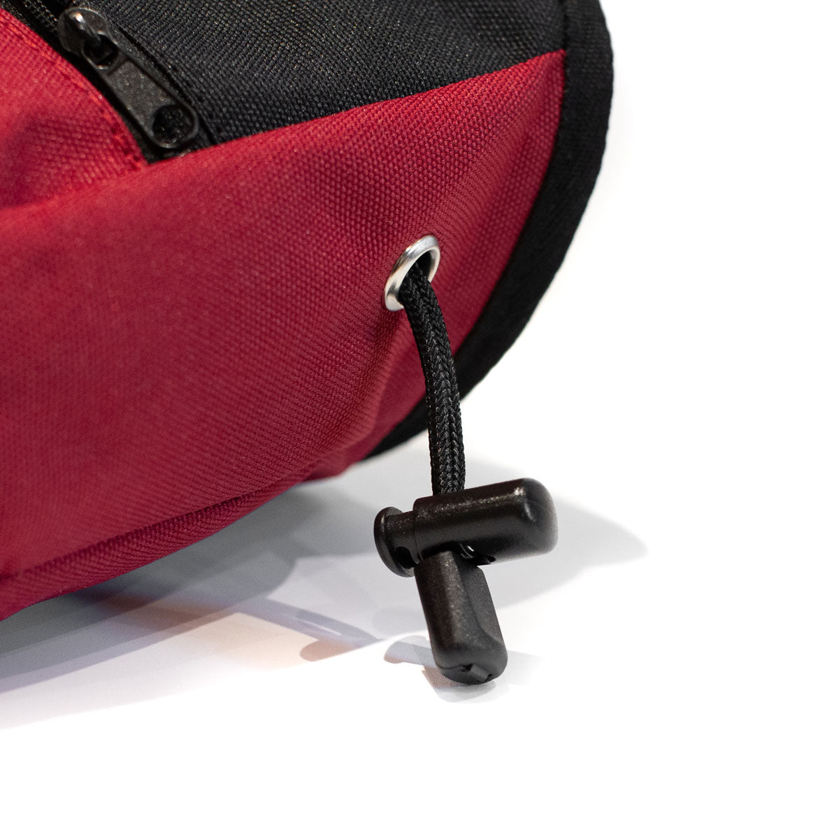 Red chalk bag with black drawcord strap and metal eyelet