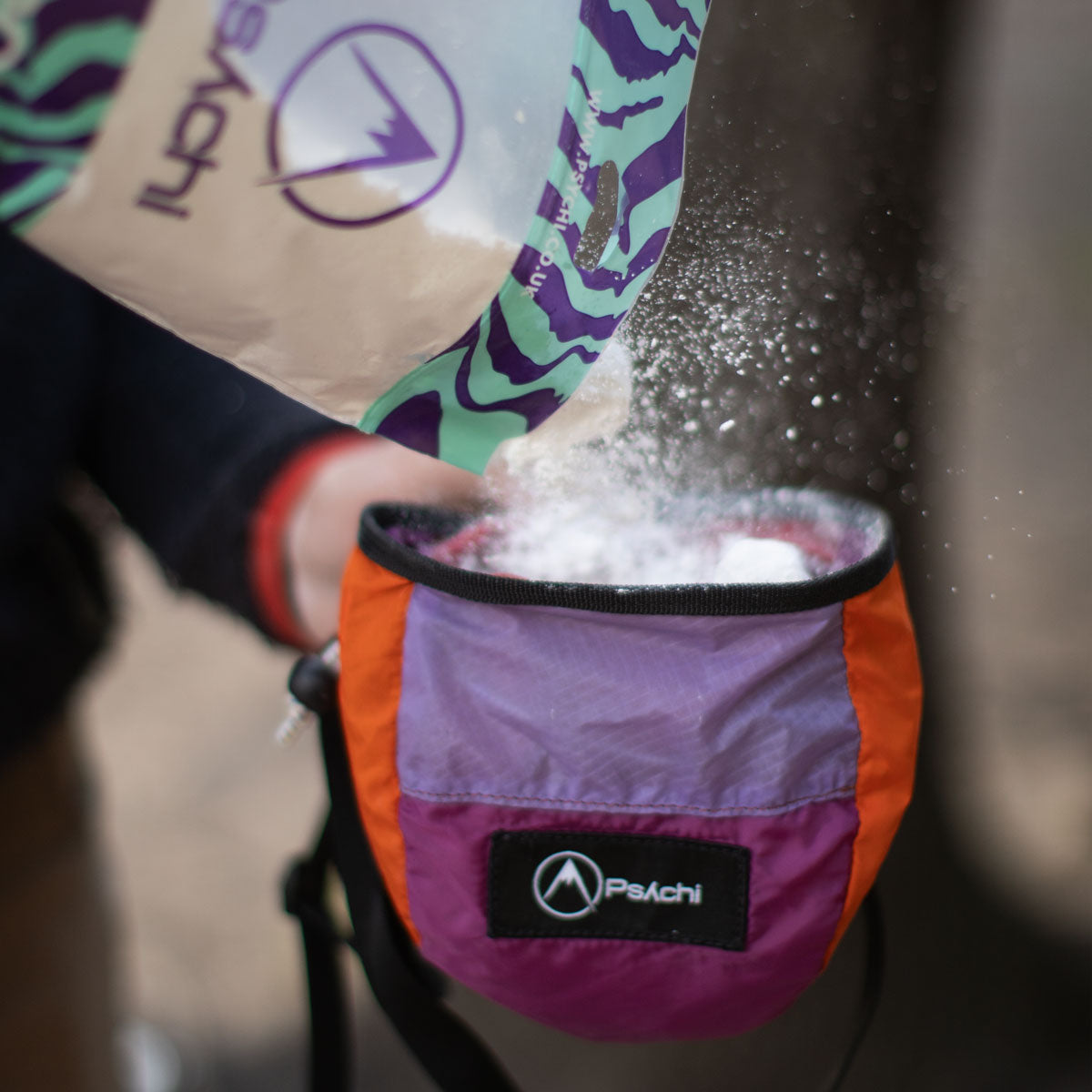 Climbing chalk powder in an open chalk bag, with white chalk spilling out