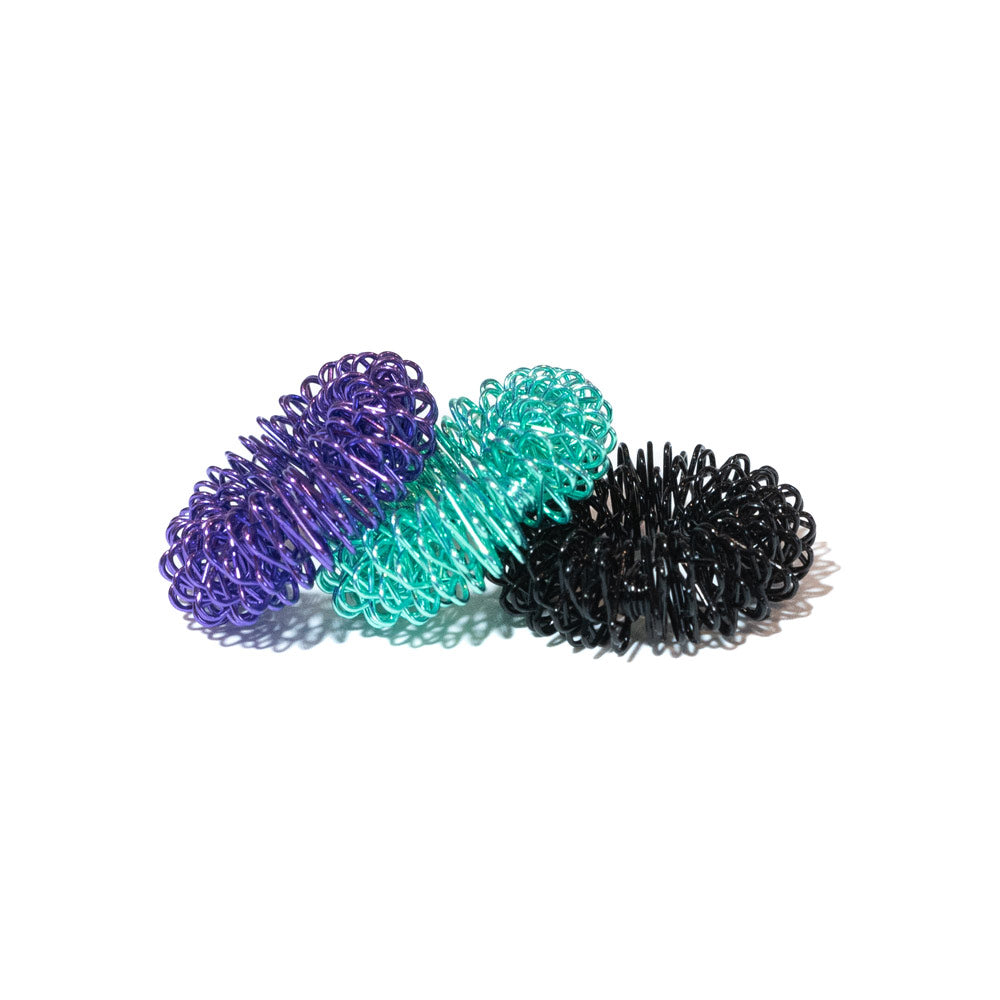 Finger coil massager 3-pack with purple, teal, and black spring rings in a row