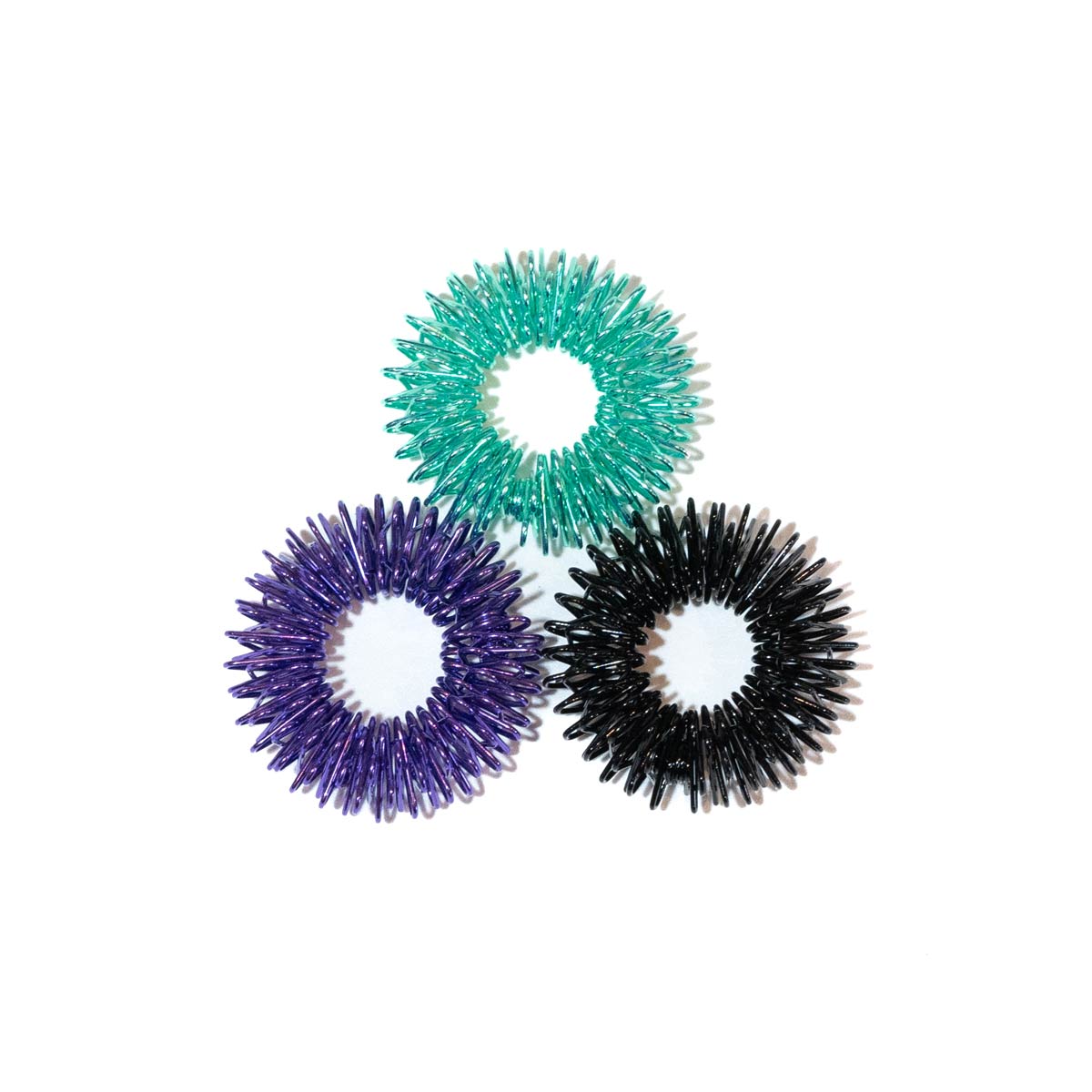 Three finger coil massager rings: purple, teal, and black with circular cores