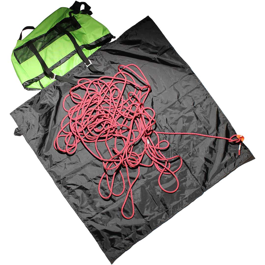 Dark grey climbing rope bag with pink rope, black straps, and fasteners