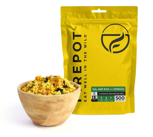 Dehydrated dal and rice with spinach meal pouch with bowl of prepared grains