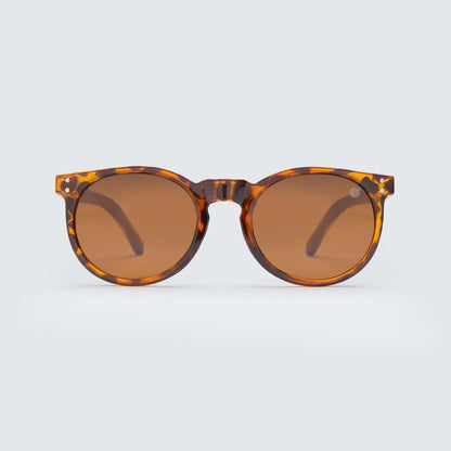 Tortoiseshell round sunglasses with brown lenses, centered bridge.