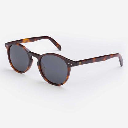 Tortoise shell sunglasses with dark round lenses and slim curved arms