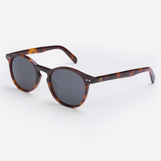 Tortoise shell sunglasses with dark round lenses and slim curved arms