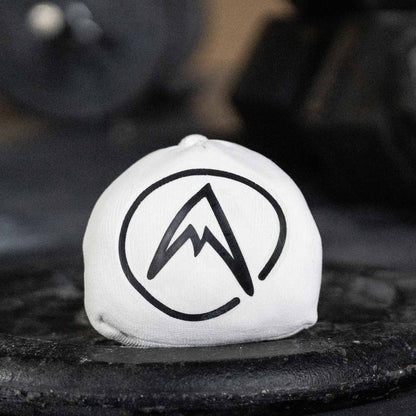 Psychi white chalk ball with mountain logo on a dark surface