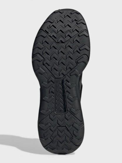 Black boot outsole tread with zigzag traction pattern and toe ridge