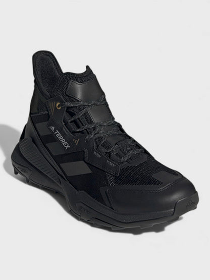 Black mid-top lace-up trail boots with three-stripe side panels and padded collar