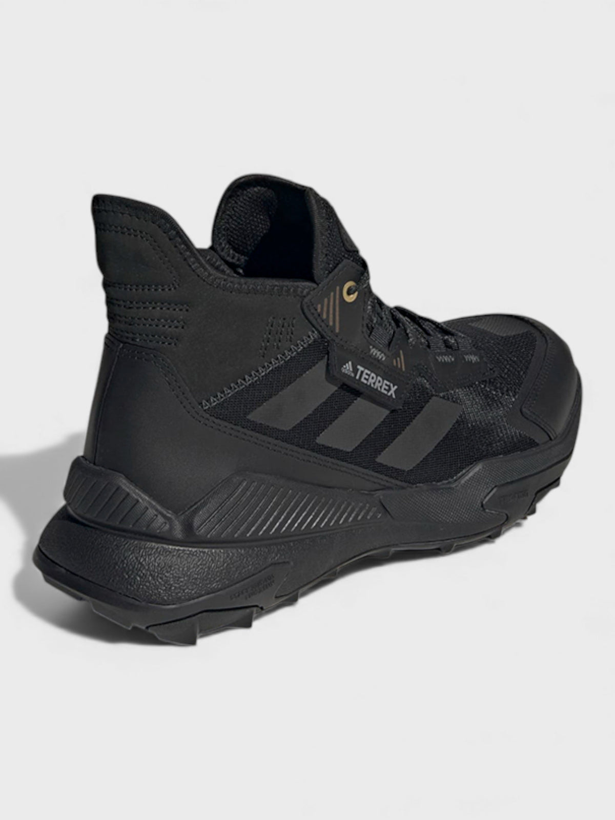 Black mid-top trail boots, lace-up design with molded heel and Terrex emblem
