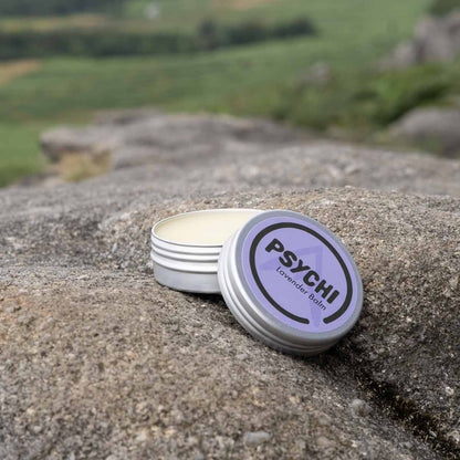 PSYCHI Lavender balm tin on stone with balm base visible