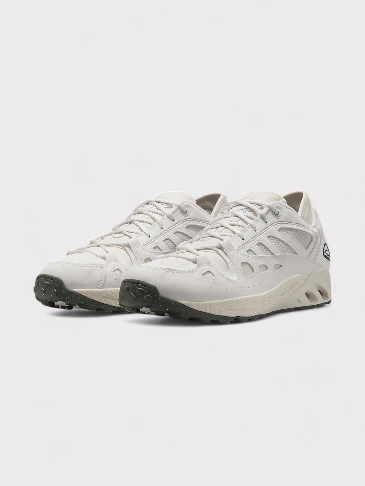Nike ACG low-top trail sneakers in white, lace-up with rugged rubber sole