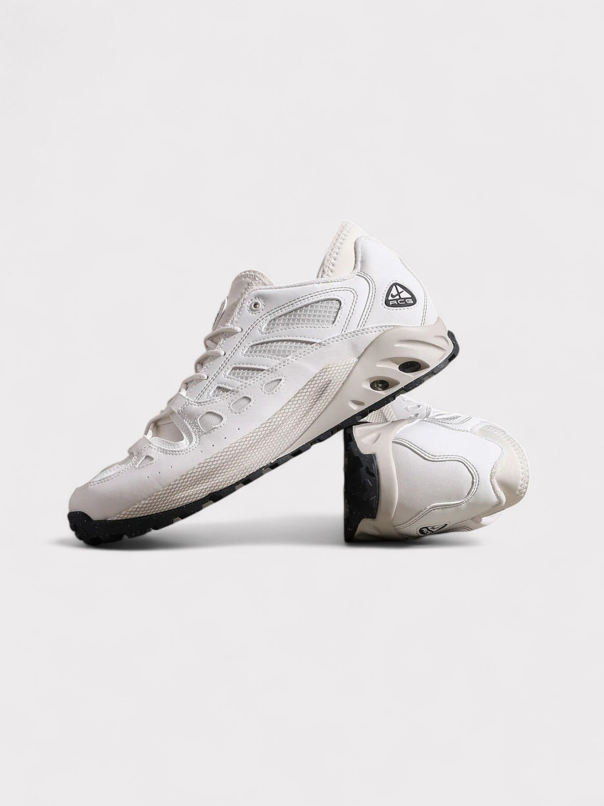 Nike ACG lace-up trail sneakers, side view in white with dark outsole