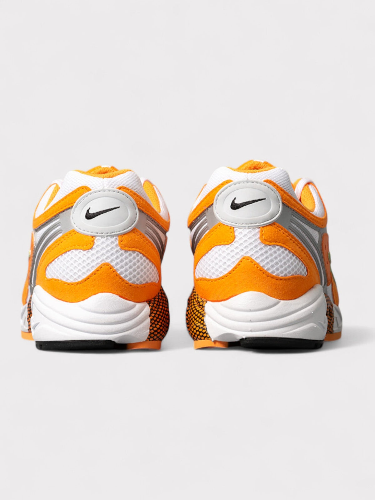Nike orange and white sneakers, rear view with heel and swoosh logo
