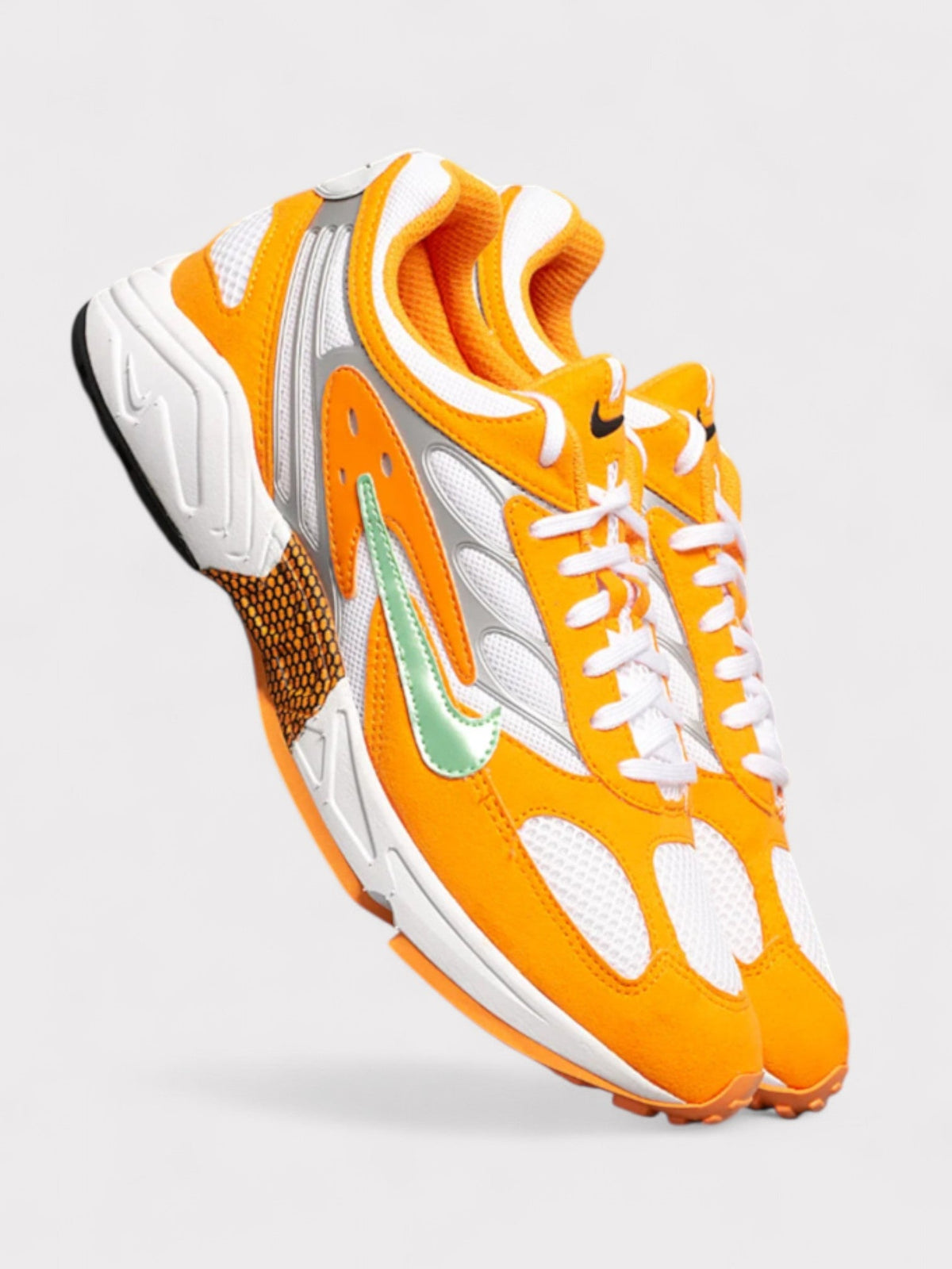 Nike orange, white, and green lace-up sneakers, side view