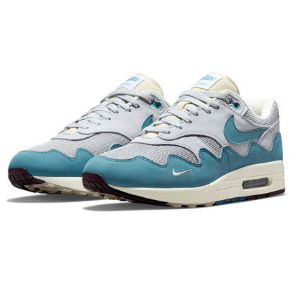 White and aqua Nike Air Max 1 trainers, side view, lace-up with Air sole unit