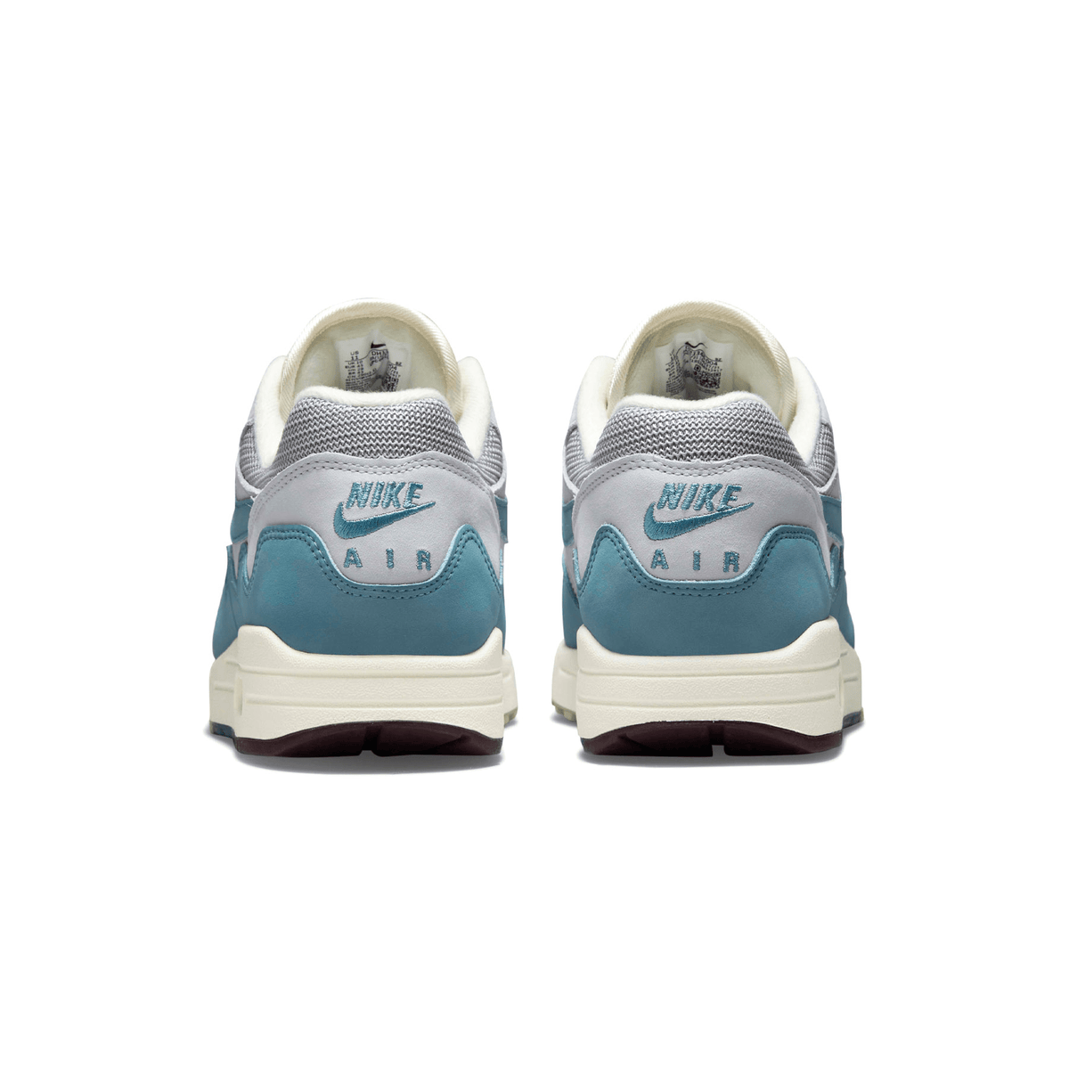 Back view of white and aqua Nike Air Max 1 trainers with Nike Air heel text