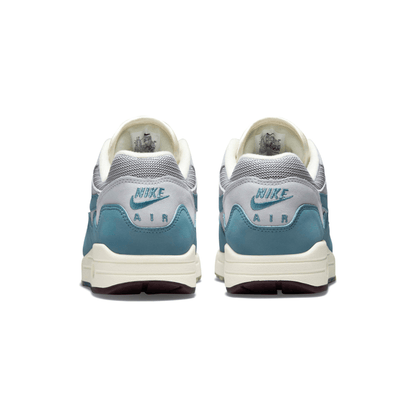 Back view of white and aqua Nike Air Max 1 trainers with Nike Air heel text