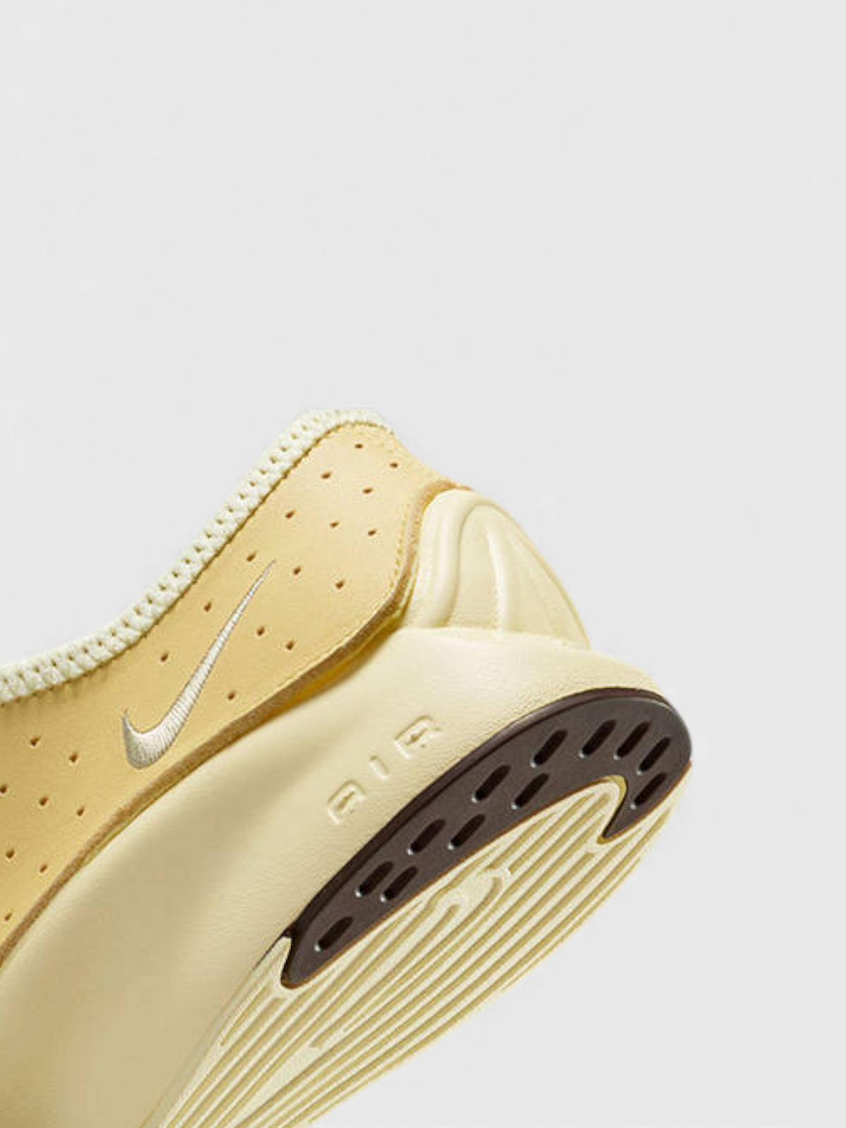 Soft yellow Nike Air heel with outsole tread and molded rubber details.