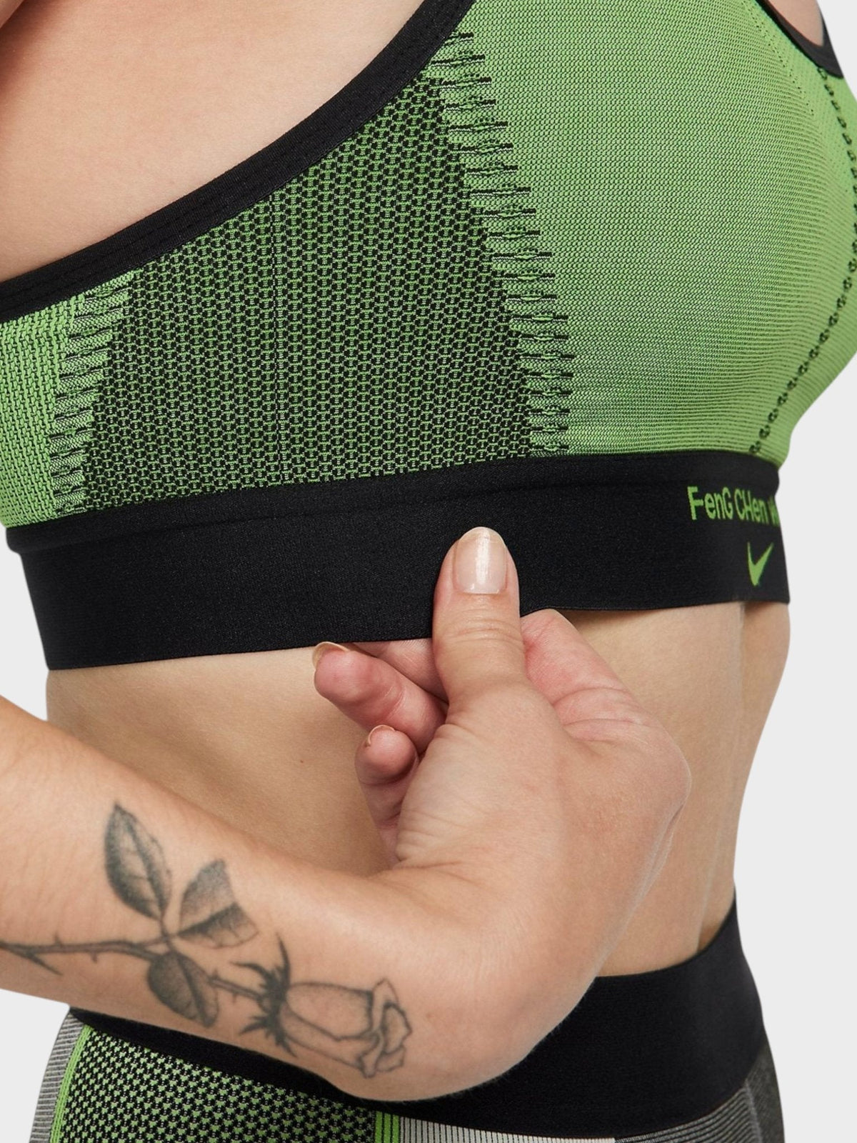 Green sports bra band with black elastic and small logo on side