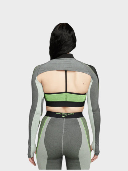 Long-sleeve knit top back view with racerback straps, green band, and gray cutout