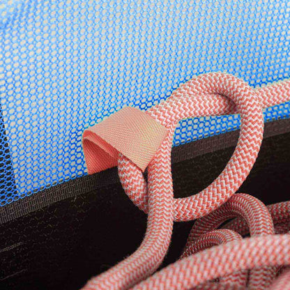 Close-up of blue mesh and orange rope on black climbing rope bucket bag strap