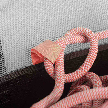Orange braided rope handle on gray mesh section of black rope bag