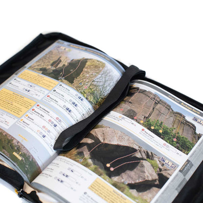 Opened weatherproof climbing guidebook cover showing map pages in black outer sleeve