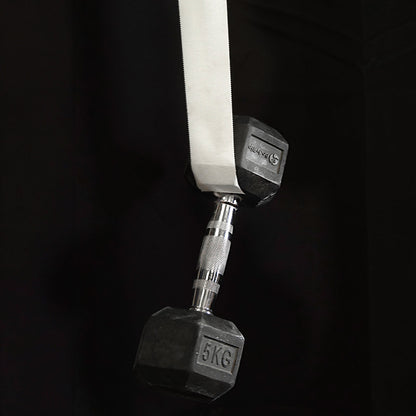 Climbing finger tape attached to a gym strap with metal dumbbell nearby