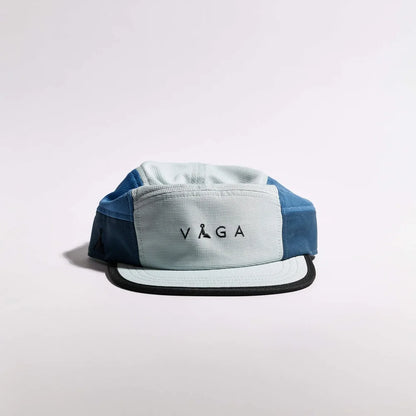 Blue and gray cap with 'Vaga' logo on a light gray background