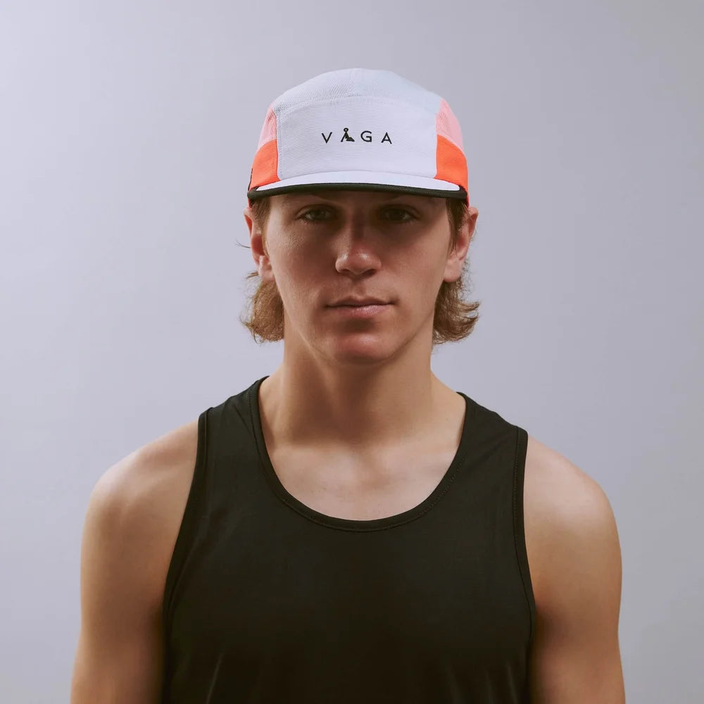 Person wearing a cap with 'Vega' branding against a plain background