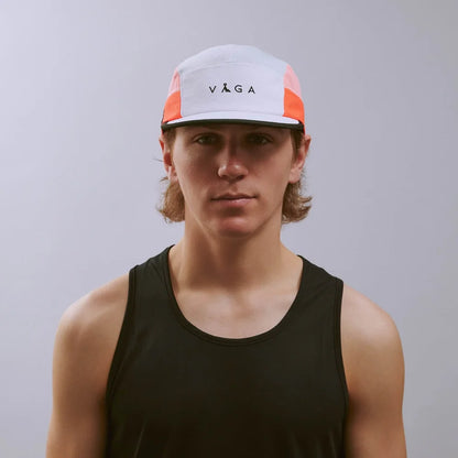 Person wearing a cap with 'Vega' branding against a plain background